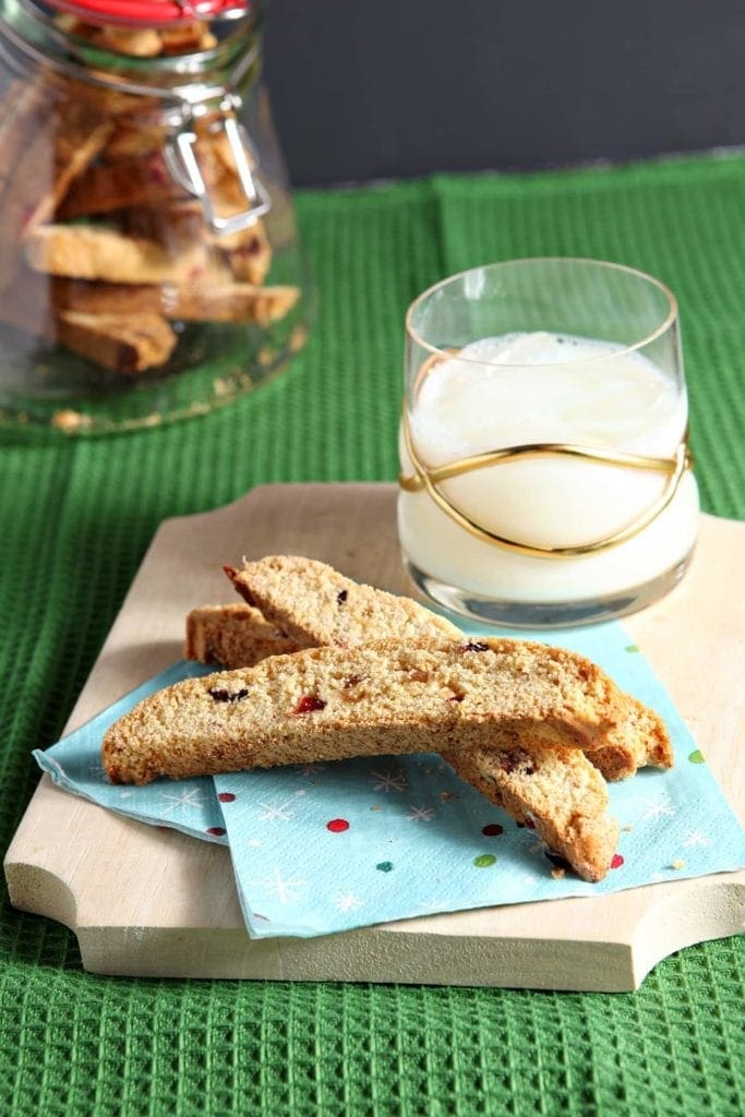 Biscotti on napkins paired with milk on a wood platter 