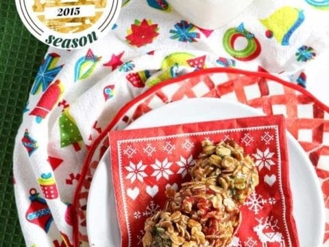 Cookies lay on holiday napkin on plate next to glass of milk 