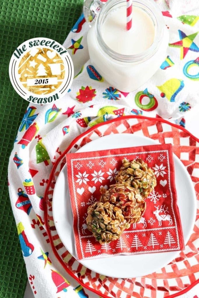 Cookies lay on holiday napkin on plate next to glass of milk 