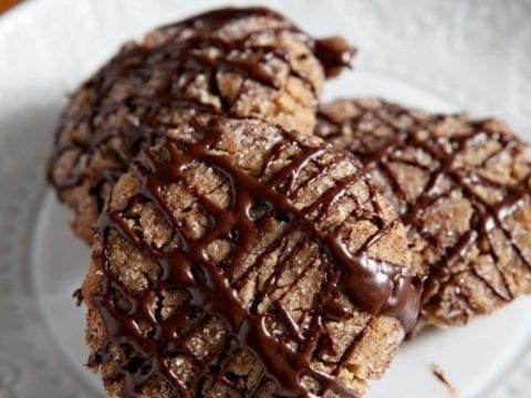 A white plate holds several Vegan Peanut Butter Espresso Cookies