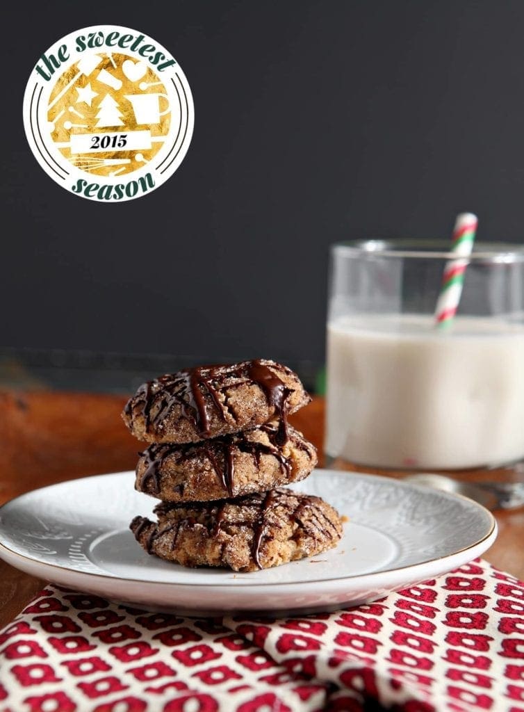 Stack of cookies on plate next to glass of milk 