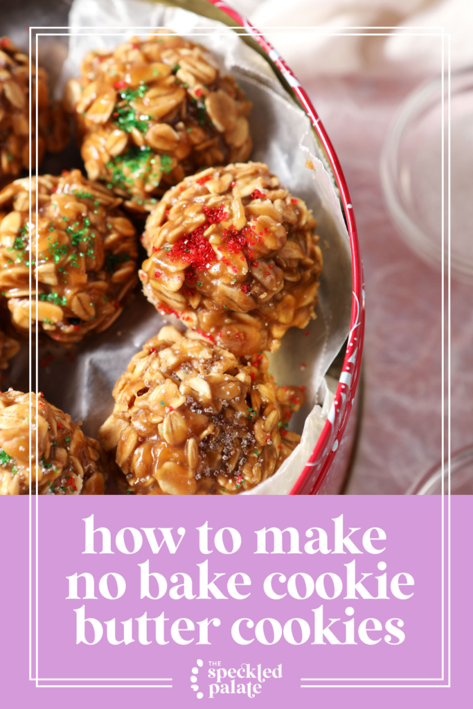 Side angle of a cookie tin of Christmas-colored No Bake cookies on a pink terrazzo surface with the text how to make no bake cookie butter cookies