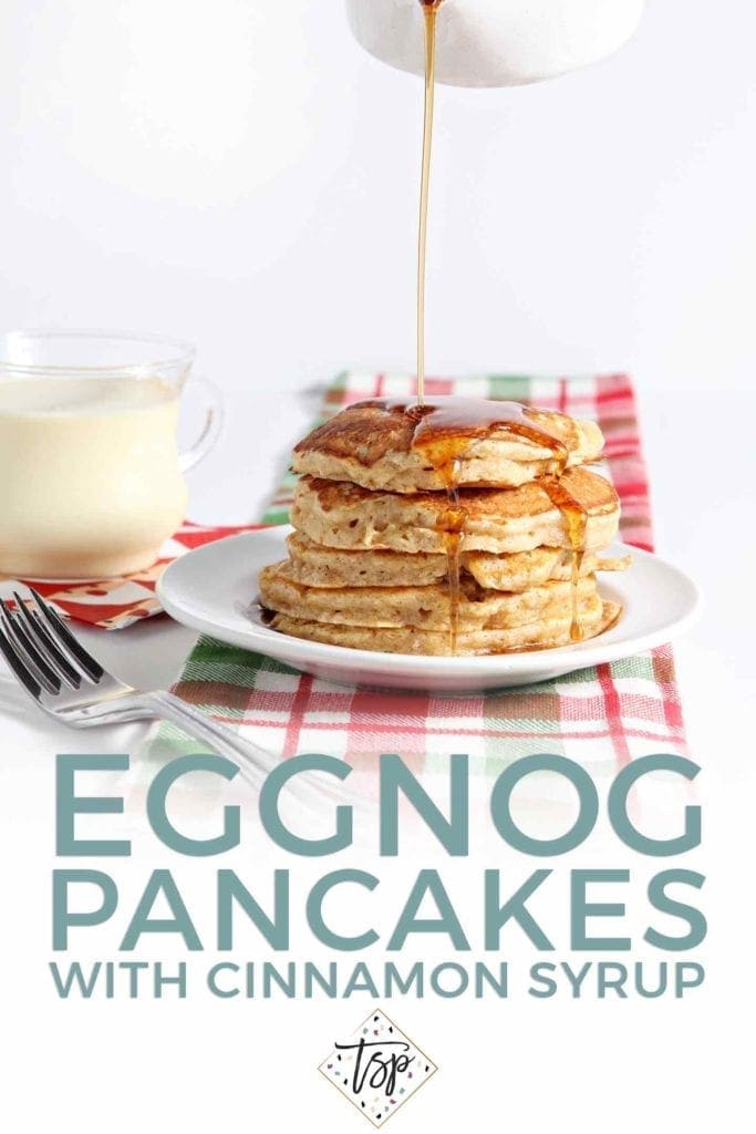 Cinnamon Syrup pours on top of a stack of Eggnog Pancakes with the text 'eggnog pancakes with cinnamon syrup'