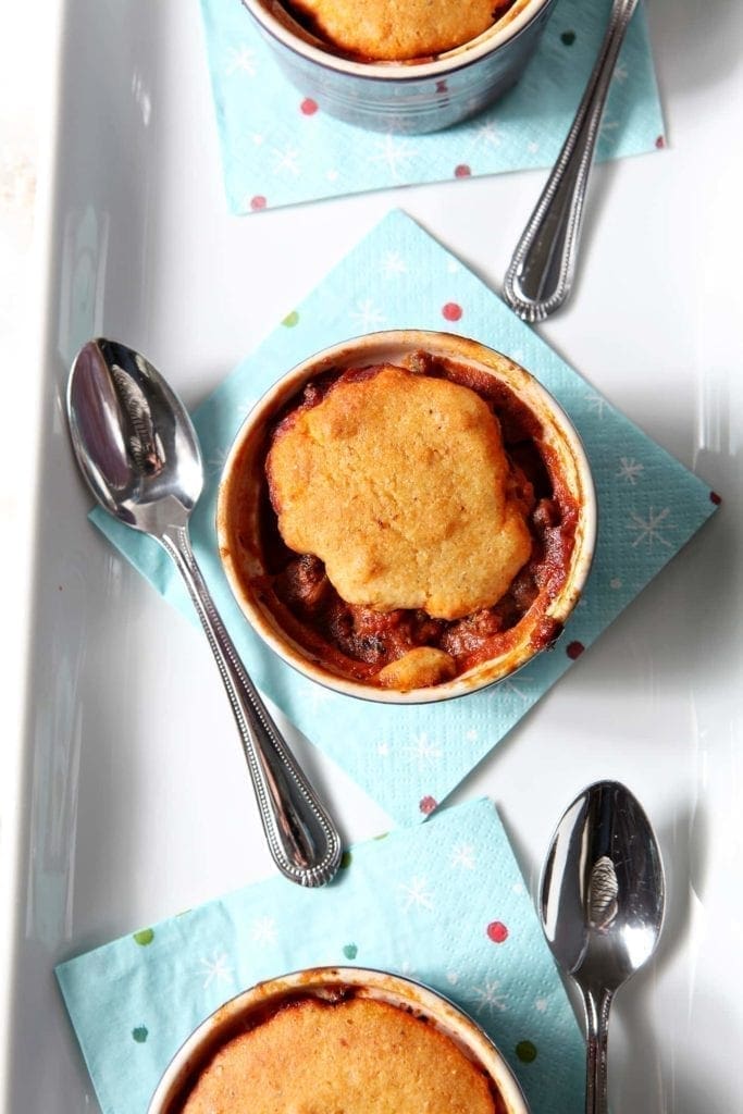 Overhead view of bowl of chili on top of napkin with spoon 