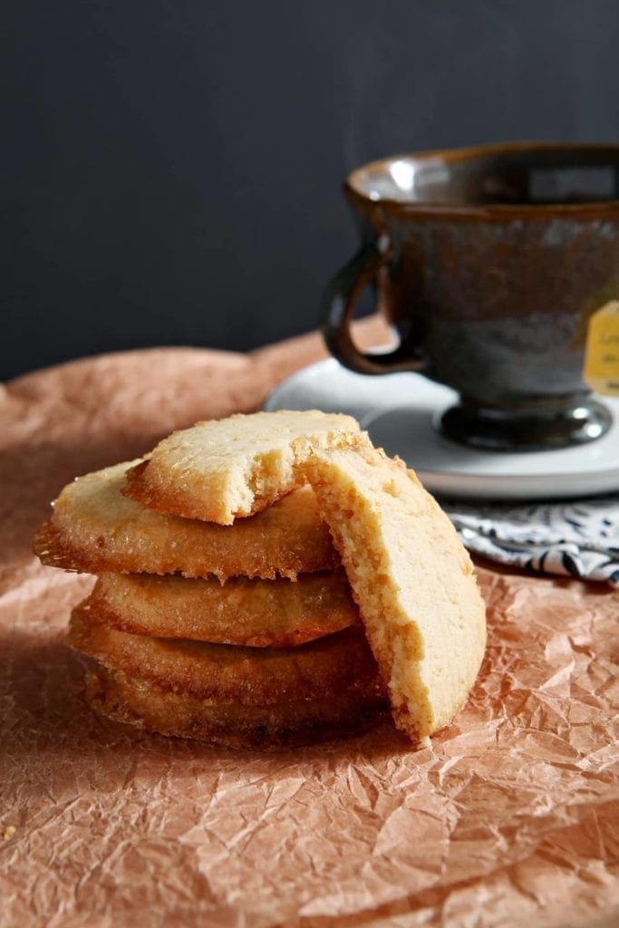 Stacked lemon honey shortbread in front of cup of tea 