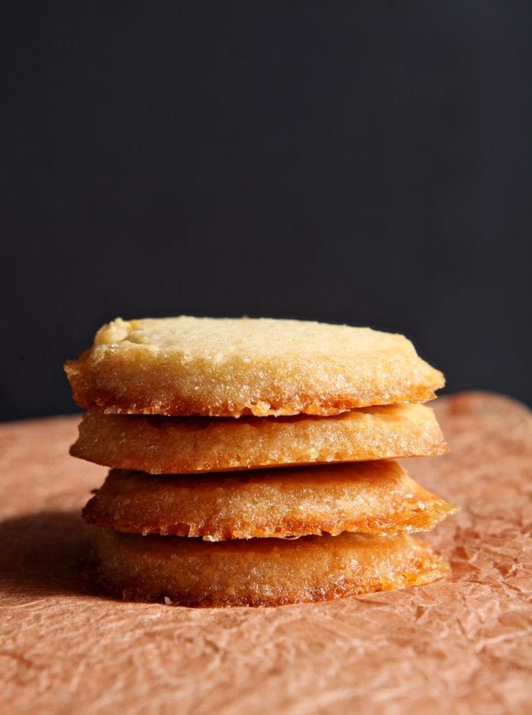 Close up of stacked lemon honey shortbread on wood table