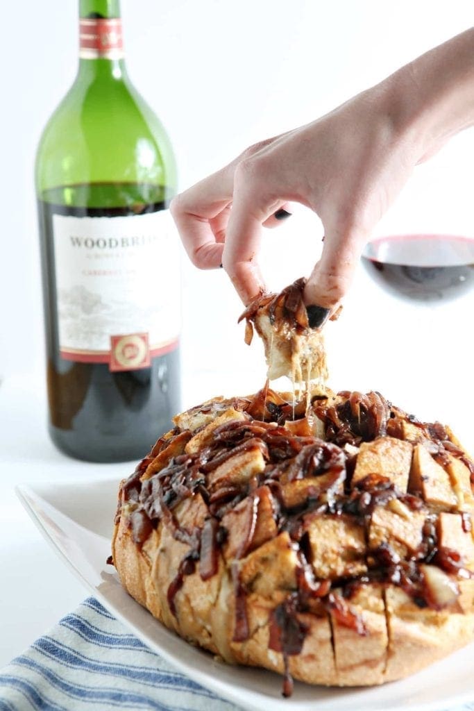 hand pulling apart french onion pull apart bread