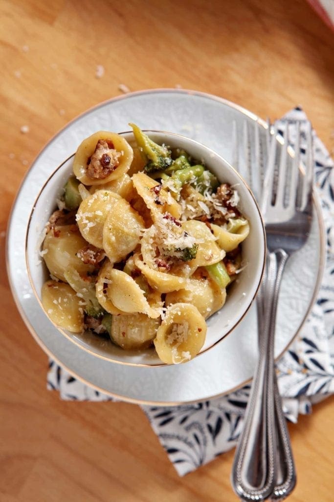 Overhead view of turkey broccoli orecchiette in white bowl with fork 