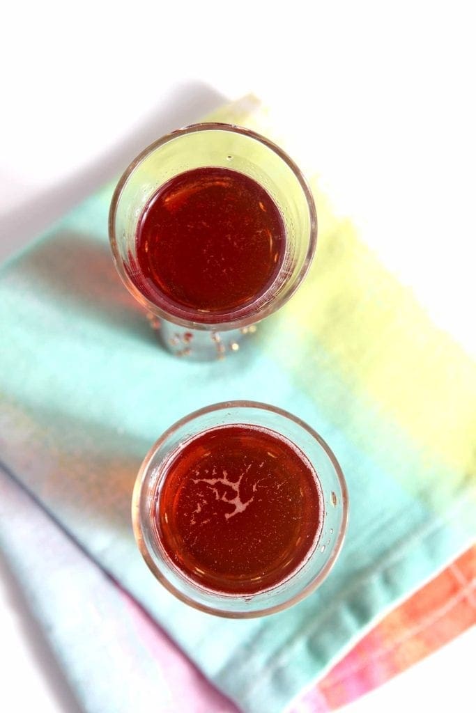 Overhead view of ginger pomegranate experiment drinks on linens 