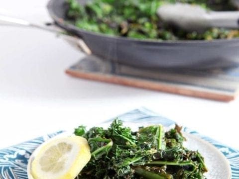 Small plate of Lemon Kale with slice of lemon