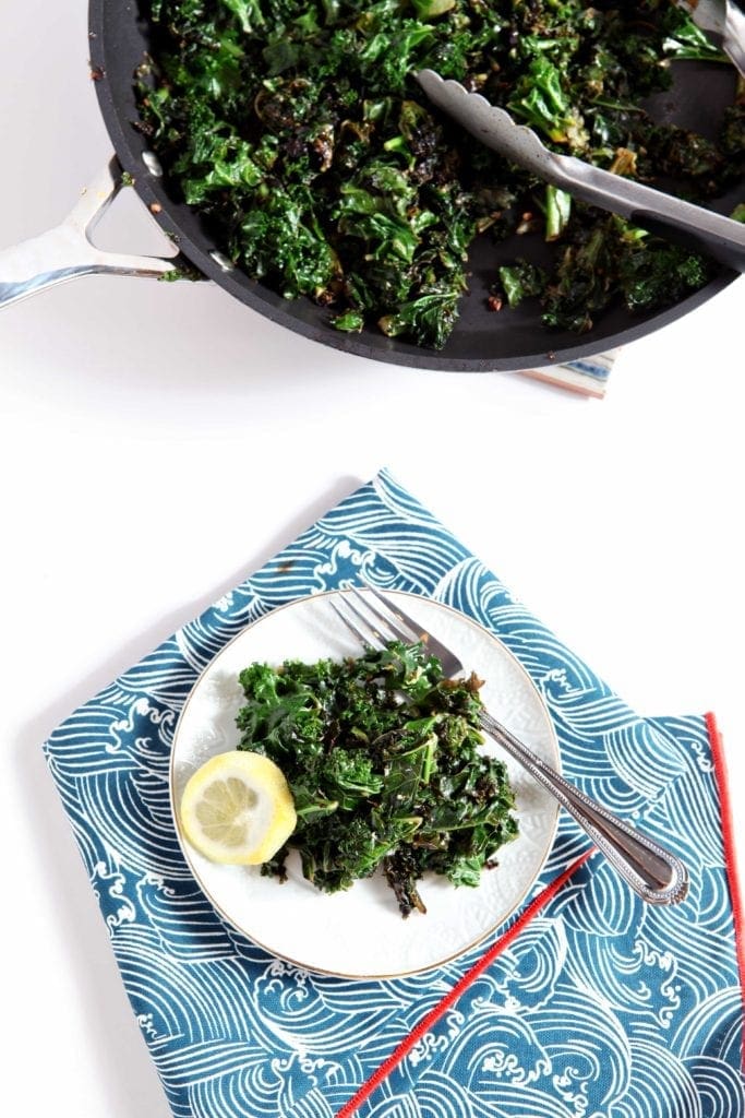 Lemon Kale on small plate with fork and lemon slice garnish 