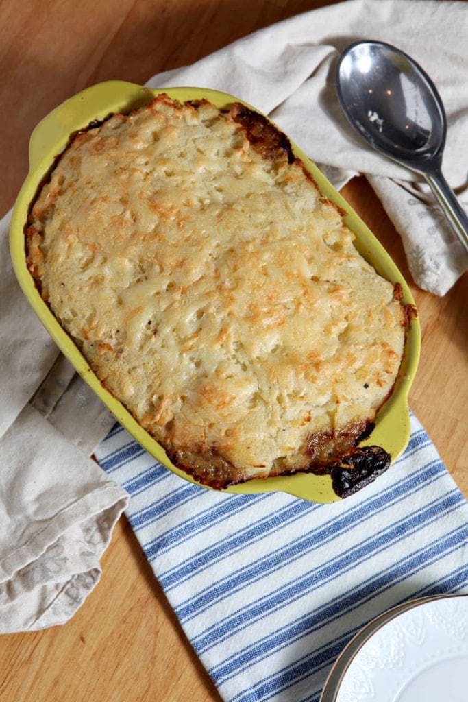 Overhead view of cooked Shepard's Pie in yellow baking dish 