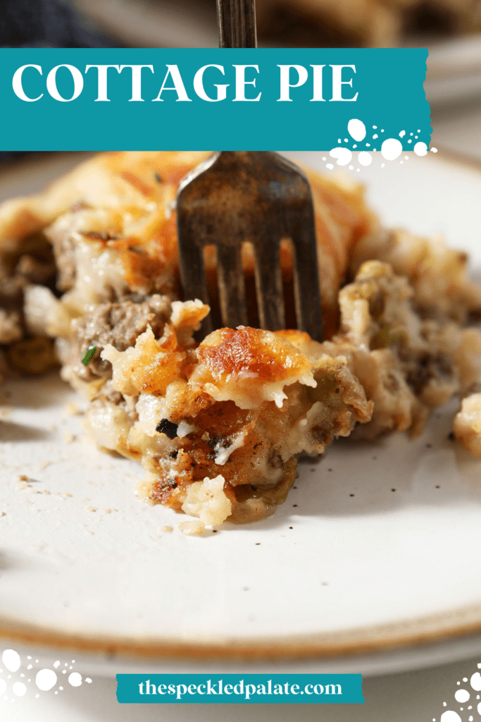 A fork delves into a plate of cottage pie topped with cheesy potatoes with the text cottage pie