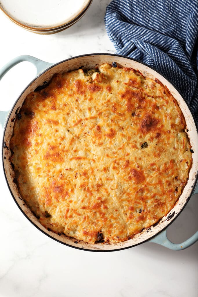 A cottage cheese with golden brown cheesy potatoes on top after baking