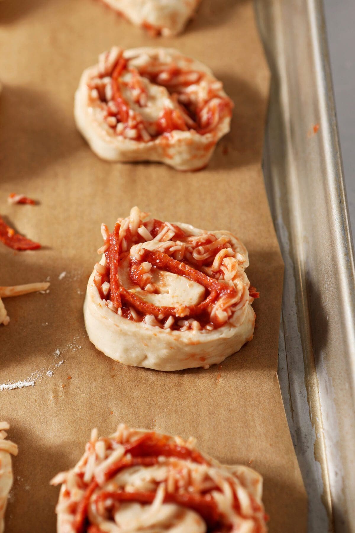 Pizza rolls on a sheet pan before baking