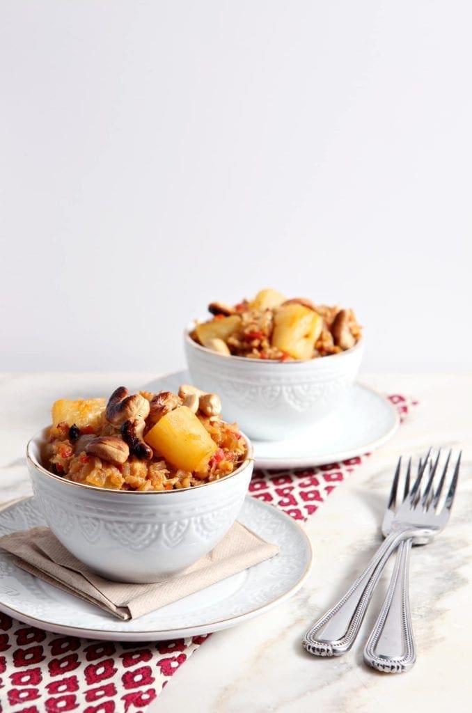 Two white bowls of Pineapple Fried Rice with forks 