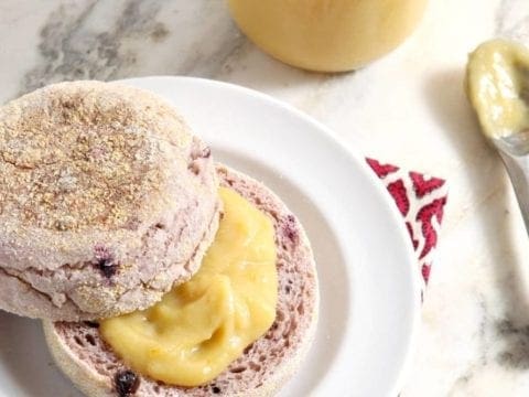 Orange curd spread on top of sliced muffin