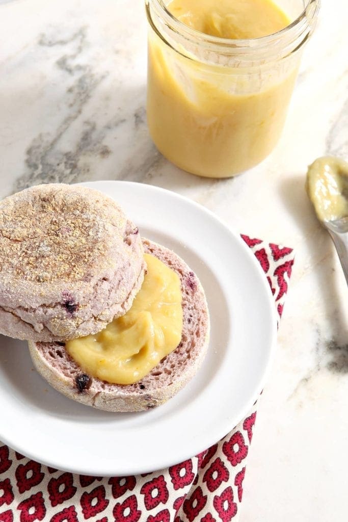 Orange curd spread on top of sliced muffin 