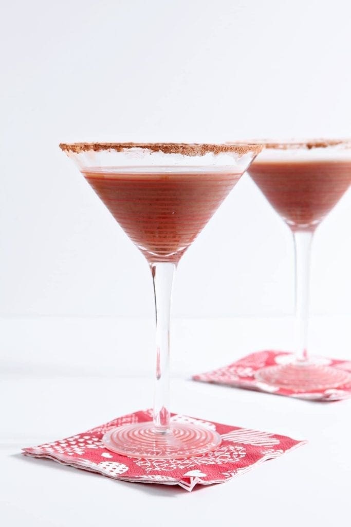 Two cocktail glasses of Vanilla Hot Chocolate Martinis on red napkins 