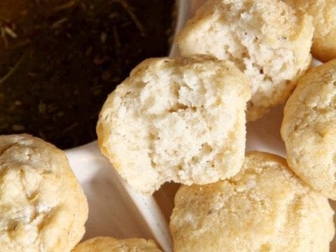 Close up of cut open bread next to dipping sauce