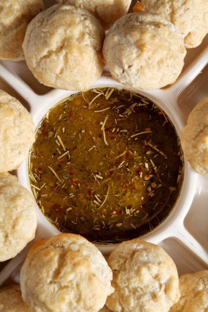 Bread surrounding bowl of olive oil parmesan dipping sauce 