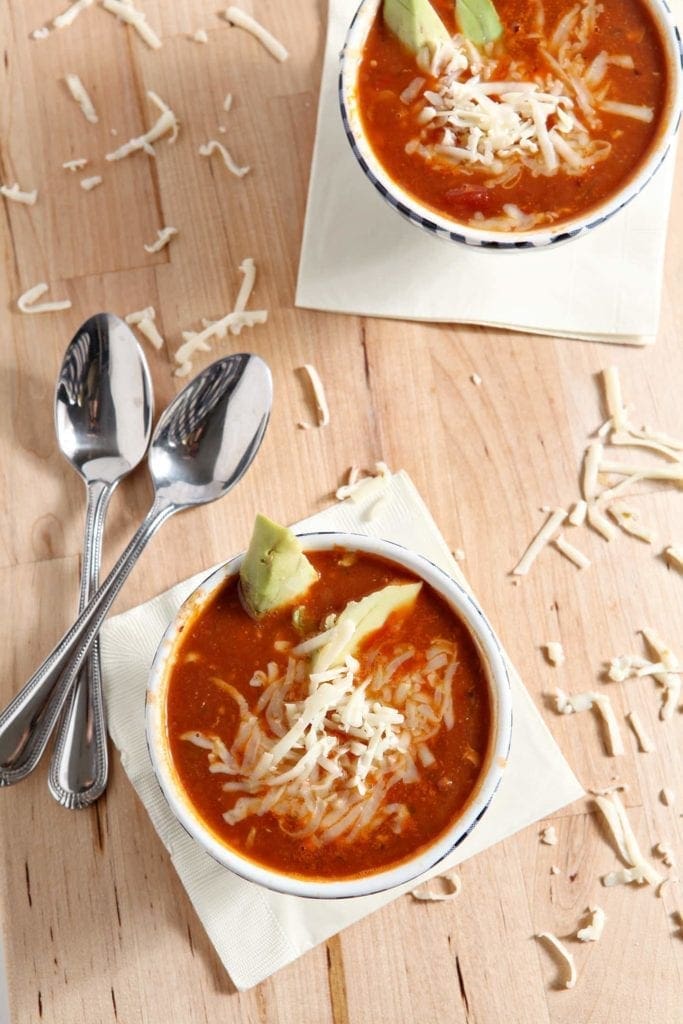 turkey taco soup in white bowls with two spoons