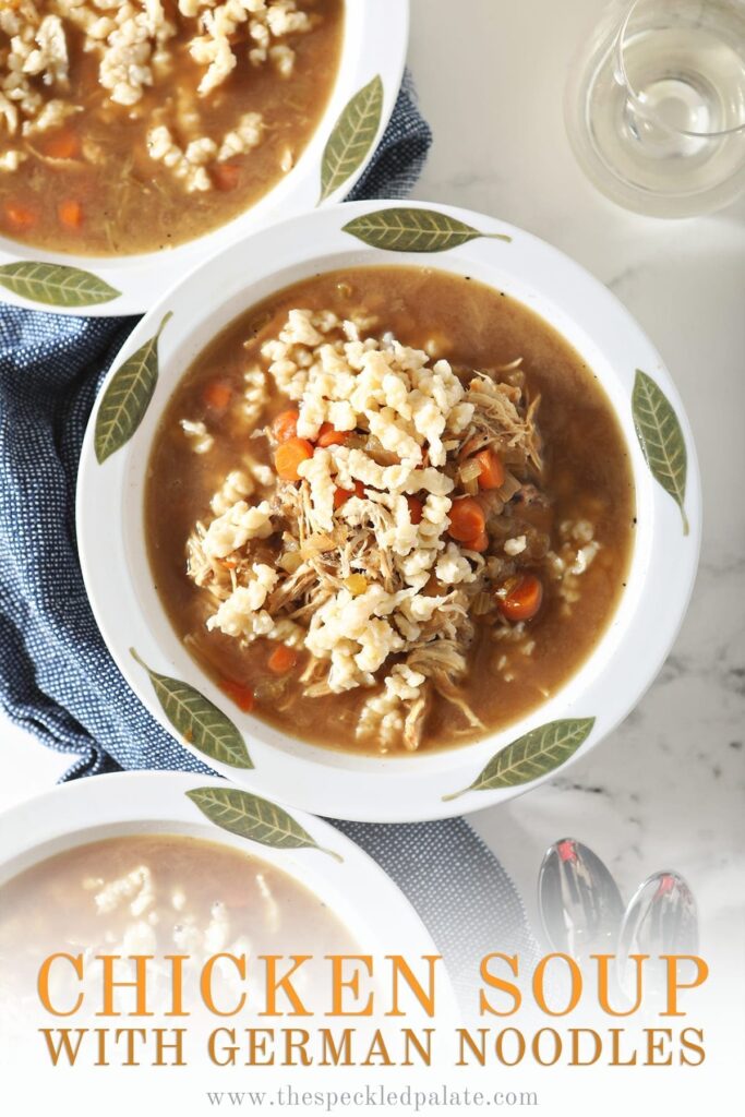 Three bowls of soup sit on top of a blue towel next to spoons and glasses of wine with the text 'chicken soup with German noodles'