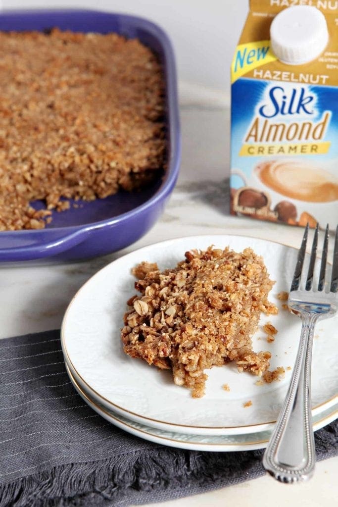 A plate of baked oatmeal in front of a Silk Almond Creamer container