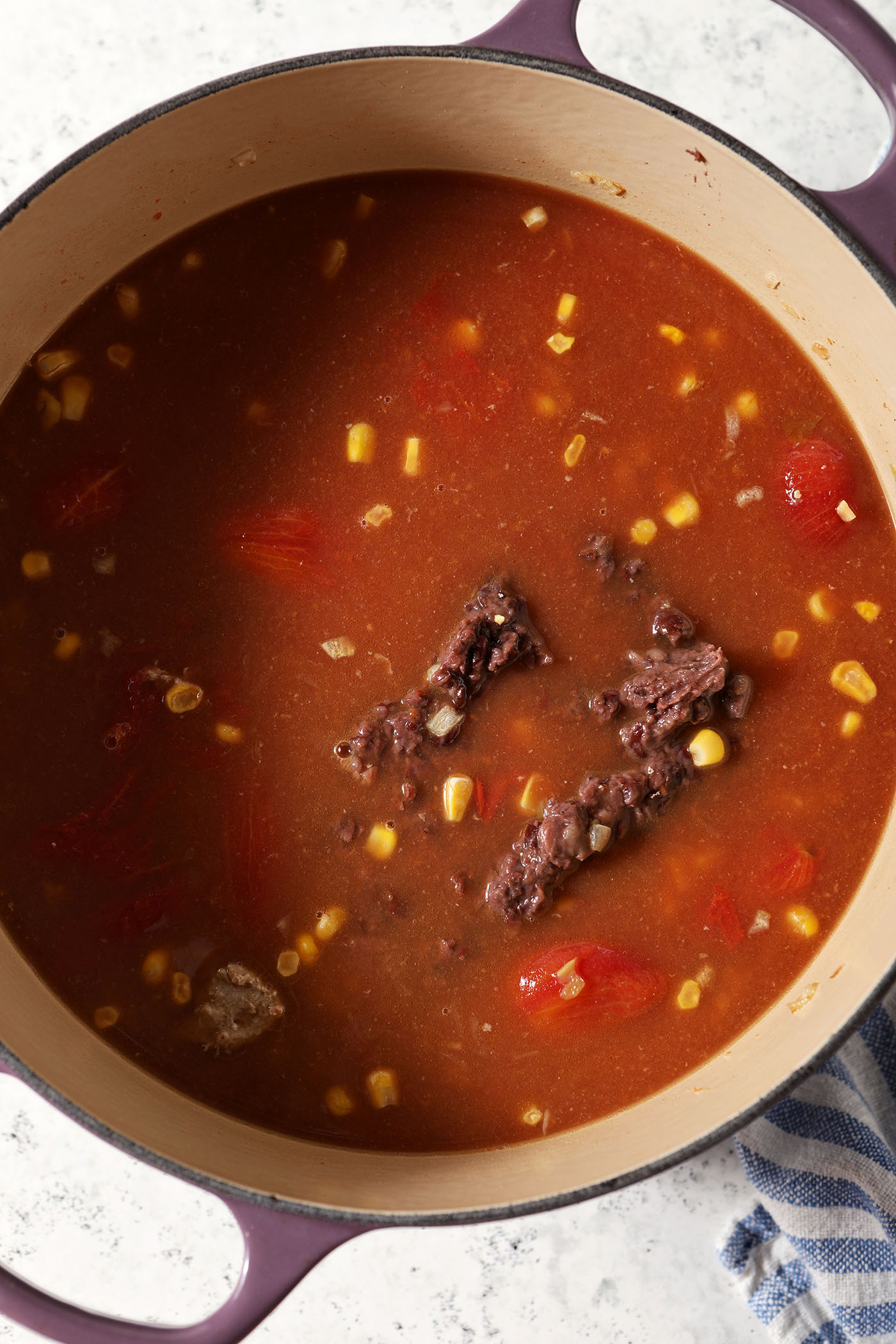 Turkey taco soup ingredients in a large dutch oven before stirring or cooking