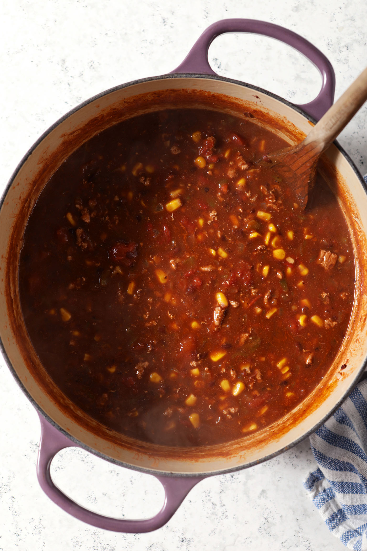 Final Ground Turkey Taco Soup in a purple dutch oven on a marble surface