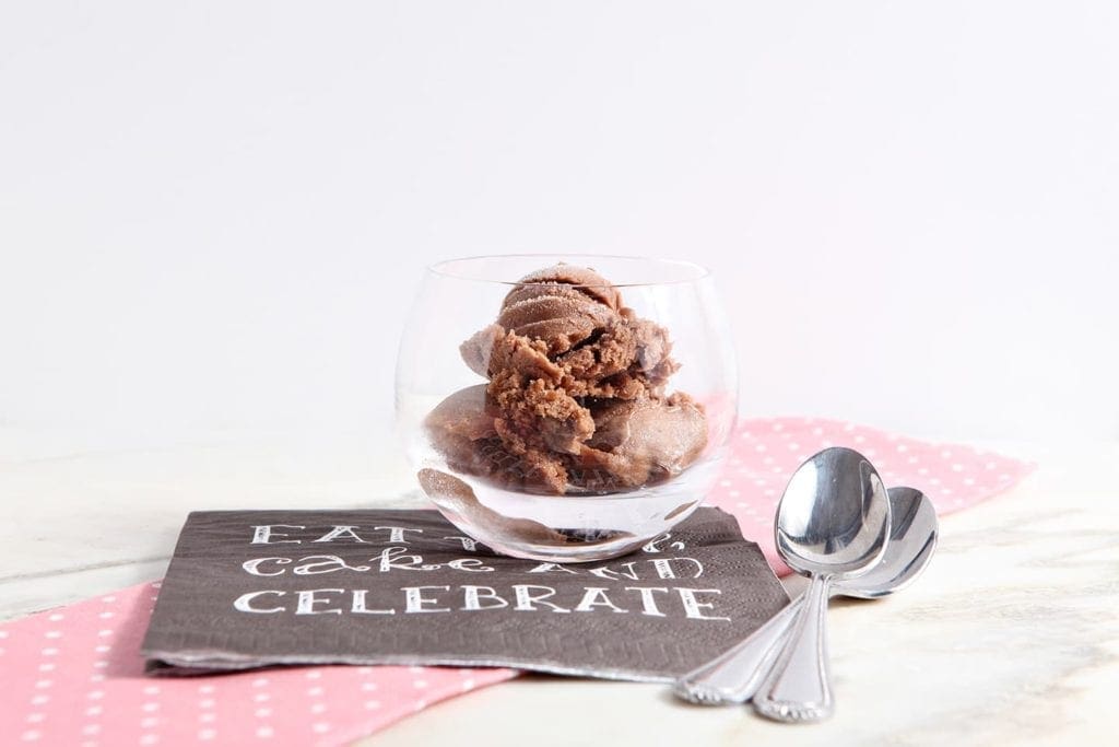 Glass of Chocolate Banana Ice Cream on a paper napkin with spoons.