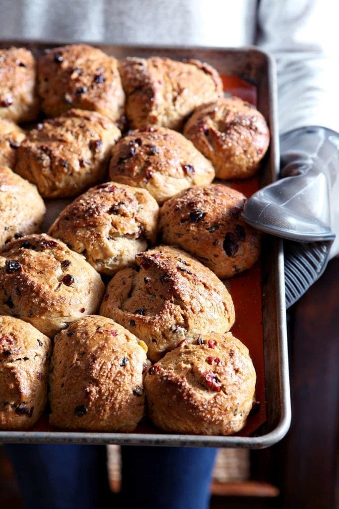 Person holding baking tray of Baked Easter Fruit Buns 