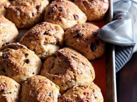 Easter Fruit Buns, being held while on a hot pan, straight out of the oven and ready for enjoying
