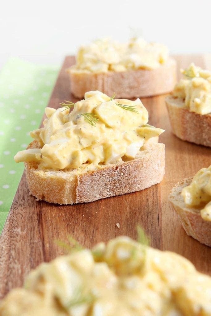 Deviled Egg Bruschetta on wood board 