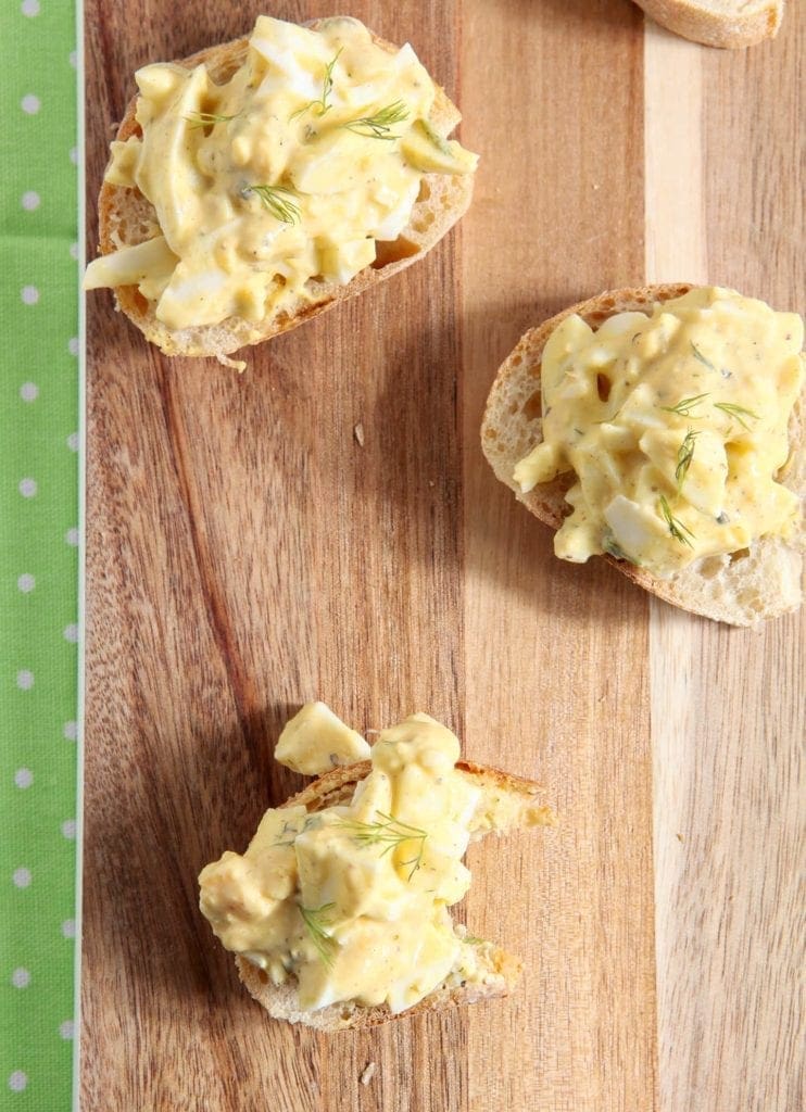 Overhead view of Deviled Egg Bruschetta on wood platter 