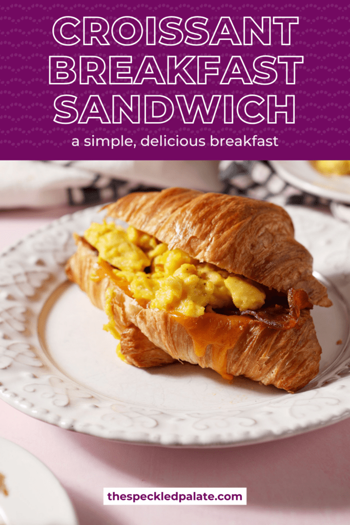 a breakfast croissant sandwich on a white plate on a pink surface next to more plates of more breakfast sandwiches with the text croissant breakfast sandwich a simple, delicious breakfast