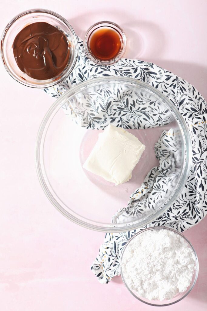 Cream cheese, chocolate, powdered sugar and vanilla in bowls