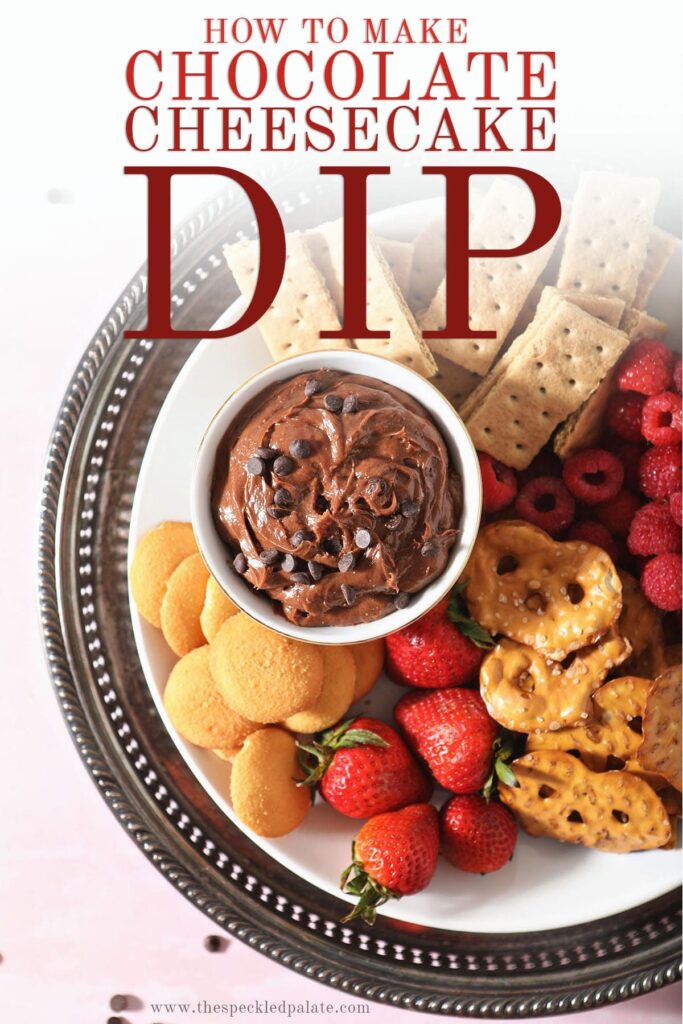 A platter holding chocolate fruit dip surrounded by crackers, fruit and cookies with the text 'how to make chocolate cheesecake dip'