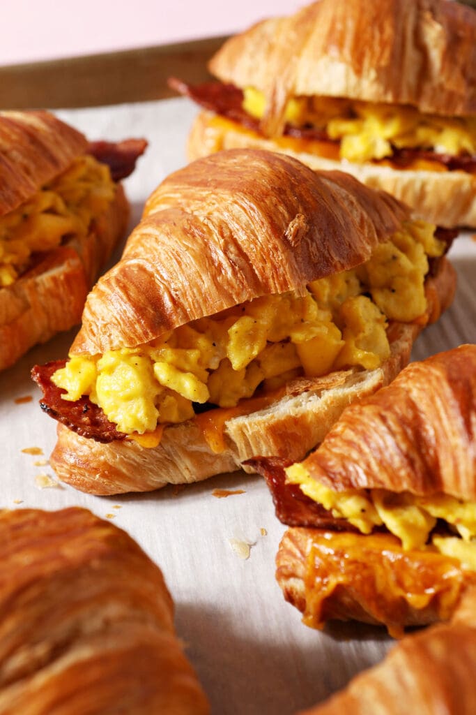 croissant breakfast sandwiches on a sheet pan after baking