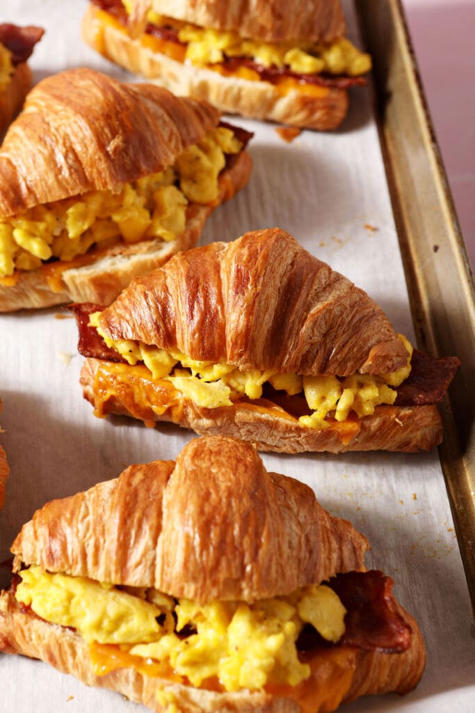 croissant breakfast sandwiches on a sheet pan after toasting