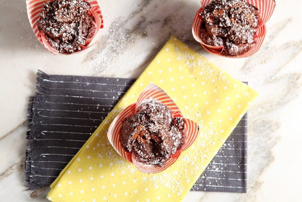 Overhead view of 3 sweet and spicy chocolate cupcakes on linens 