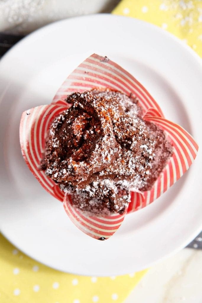 Overhead view of sweet and spicy chocolate cupcake in wrapper on plate 