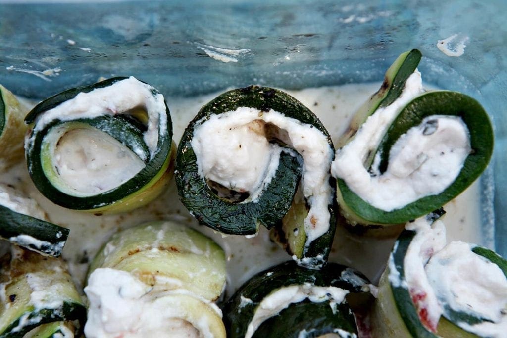 A close up of sliced grilled zucchini rollatini