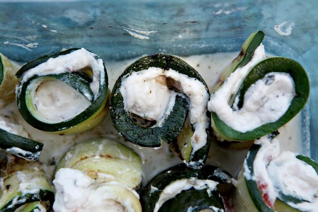 A close up of sliced grilled zucchini rollatini 