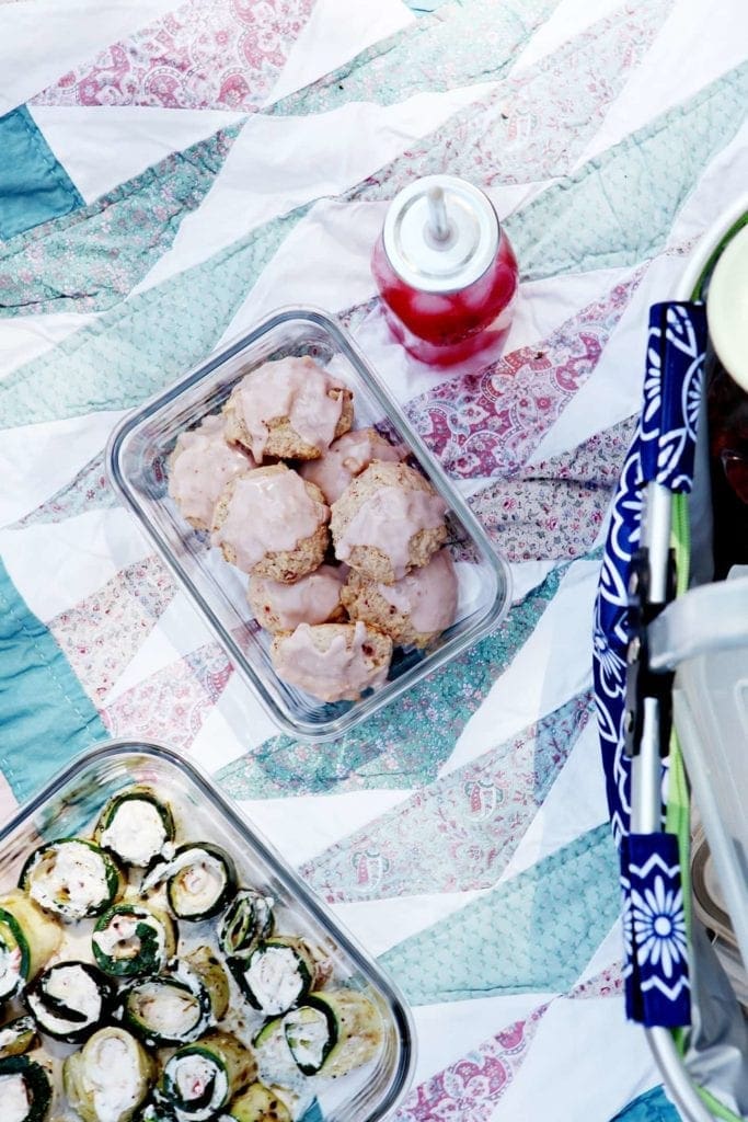 Glass dish of vegan strawberry lemonade cookies on picnic blanket 