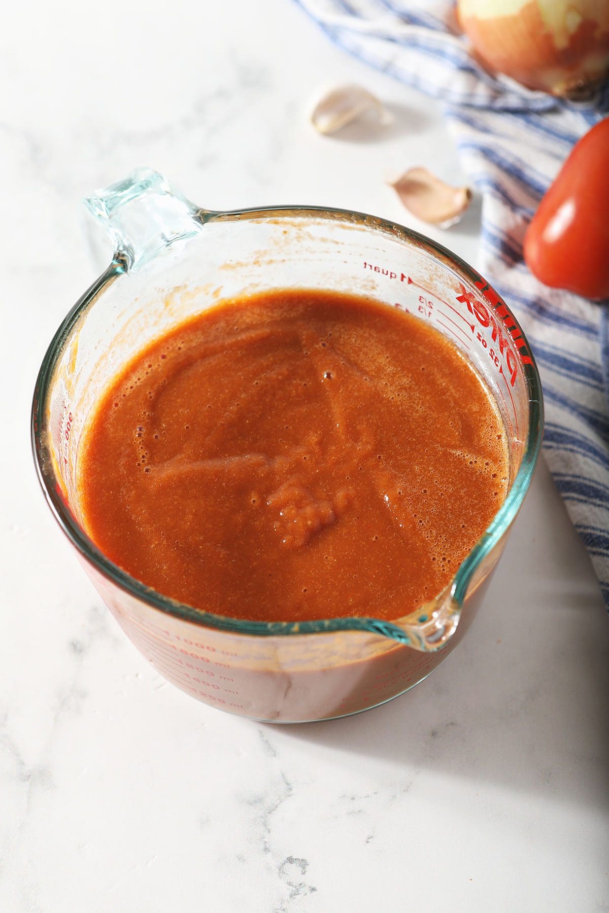 Homemade red tomato sauce in a liquid measuring cup