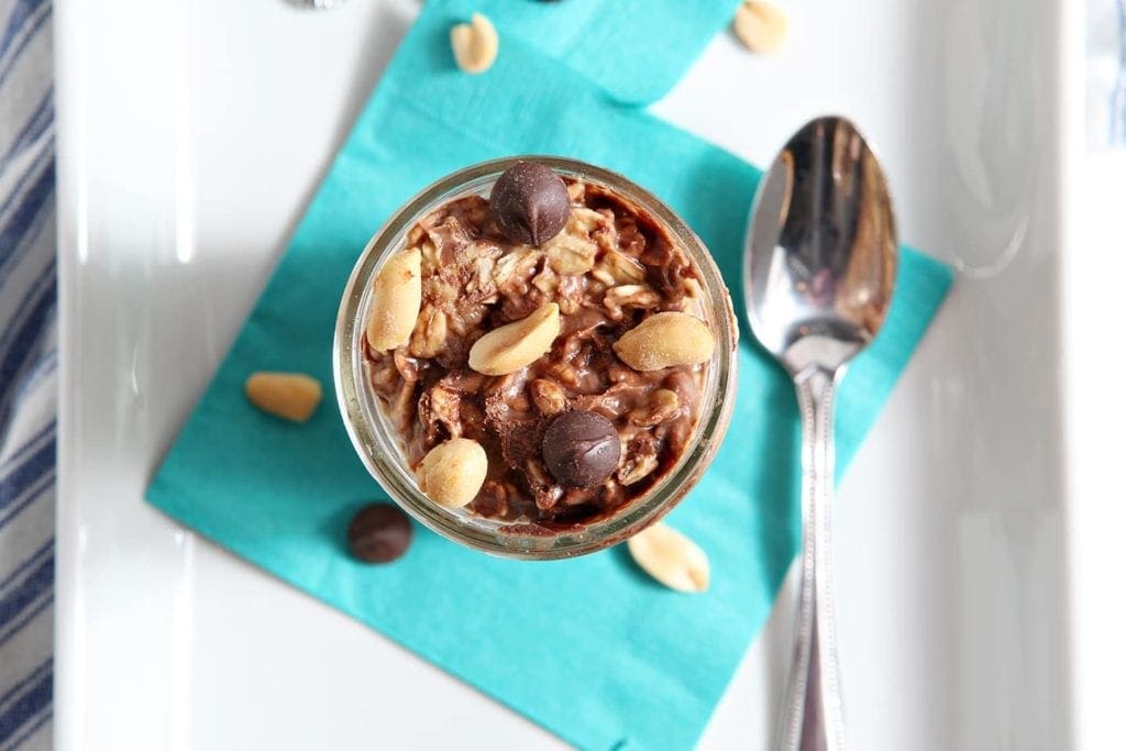 Overhead view of Peanut Butter Chocolate Chip Oats on top of napkin with spoon 