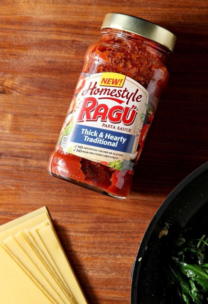 Jar of pasta sauce sitting on wood table 