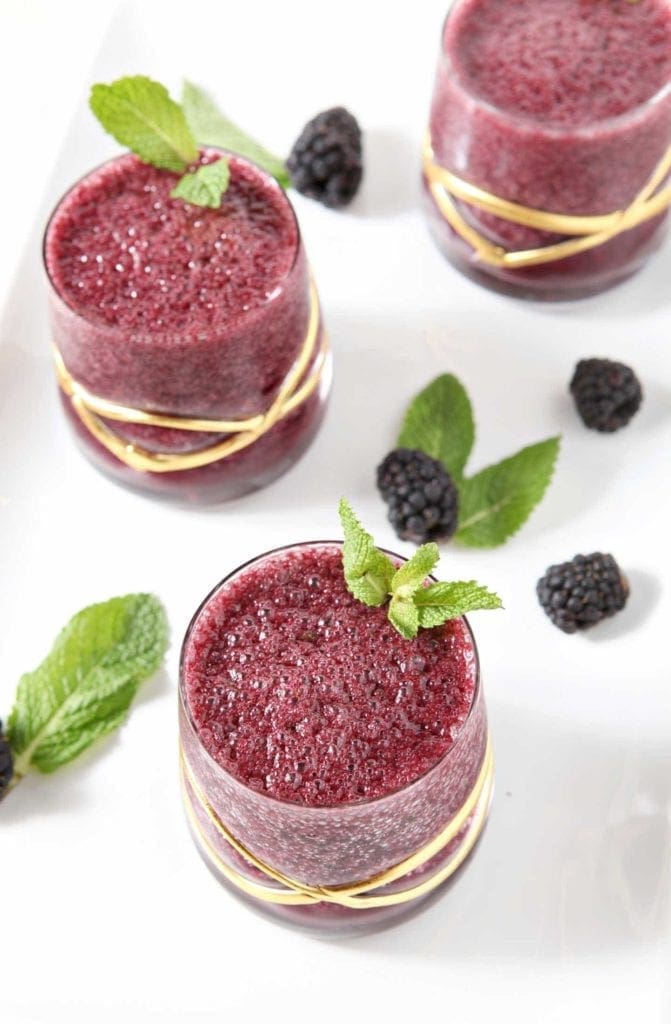 Overhead view of Blackberry Gin Slush in three glasses with garnish
