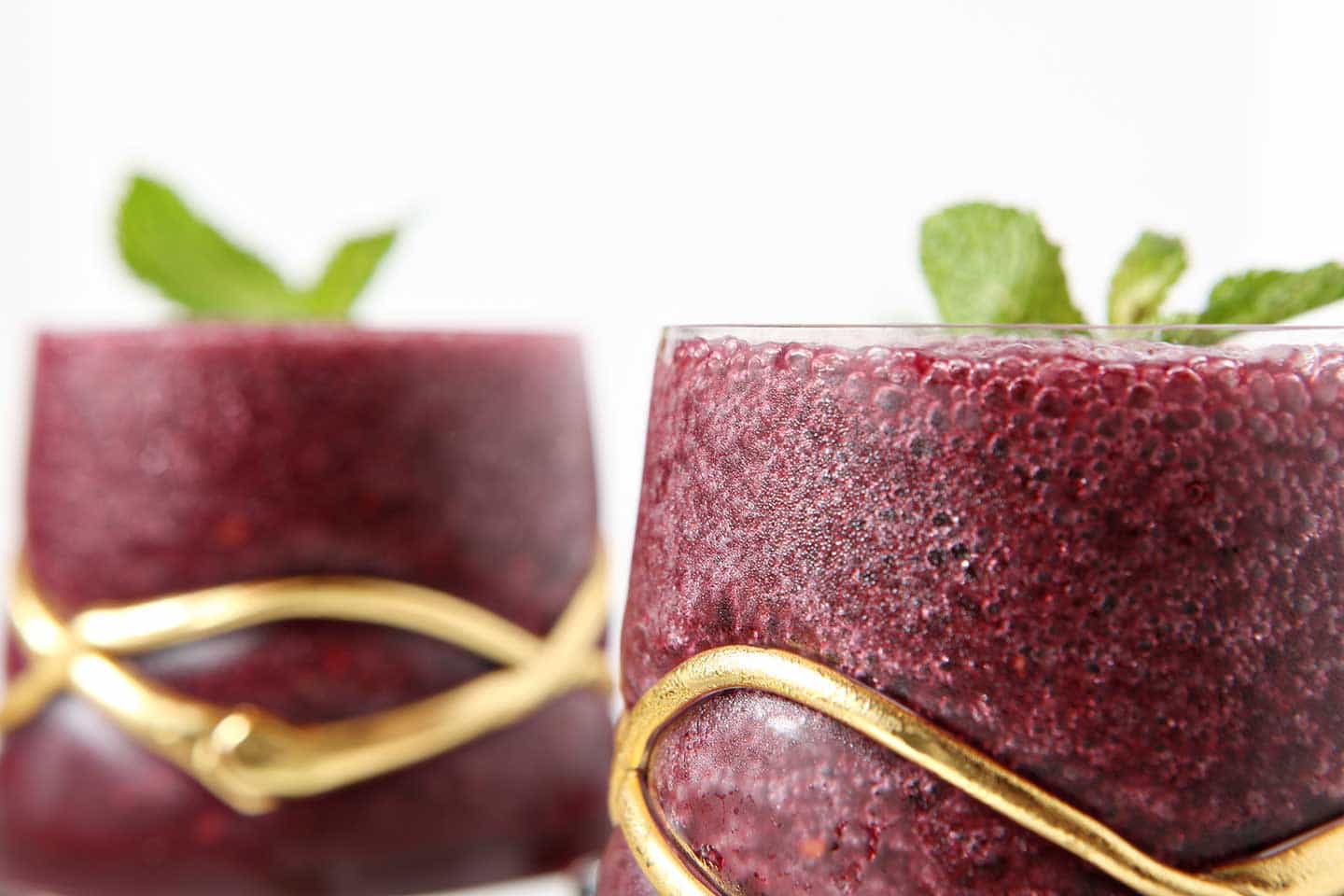 Close up of Blackberry Gin Slush in glass with mint garnish